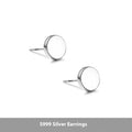 A pair of simple round flat-front sterling silver S999 ear bone stud earrings on a plain background.
