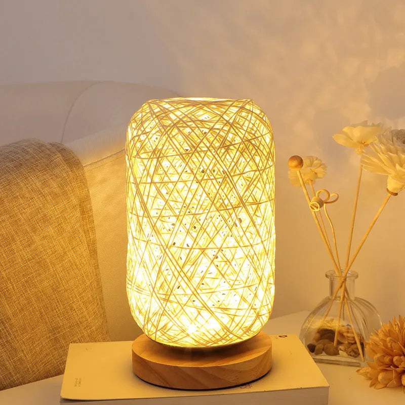 Sepak Takraw ball design desk lamp made of brown hemp rope and wood with a warm LED light.