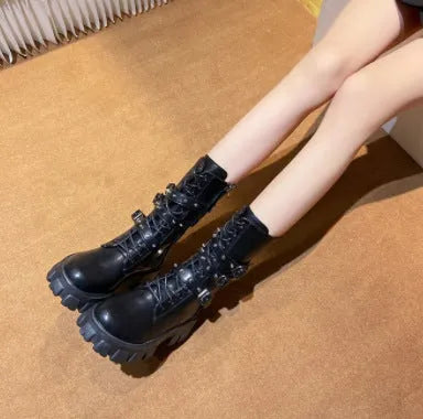 Women's black mid-calf boots with metal buckle straps and a side zipper on a white background.