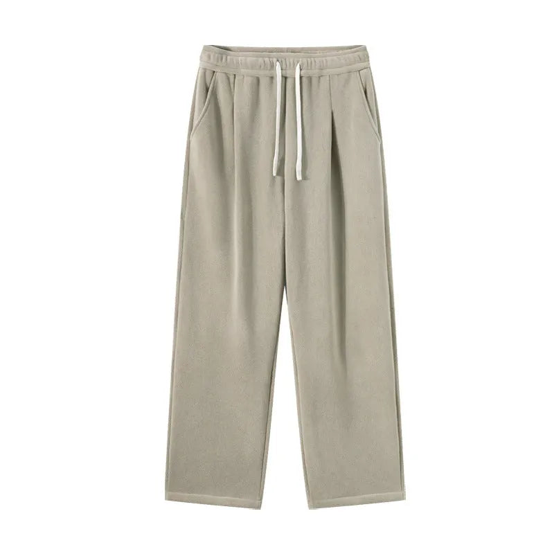 Men's double-sided polar fleece winter sports trousers in apricot colour, showing loose fit and drawstring waistband.