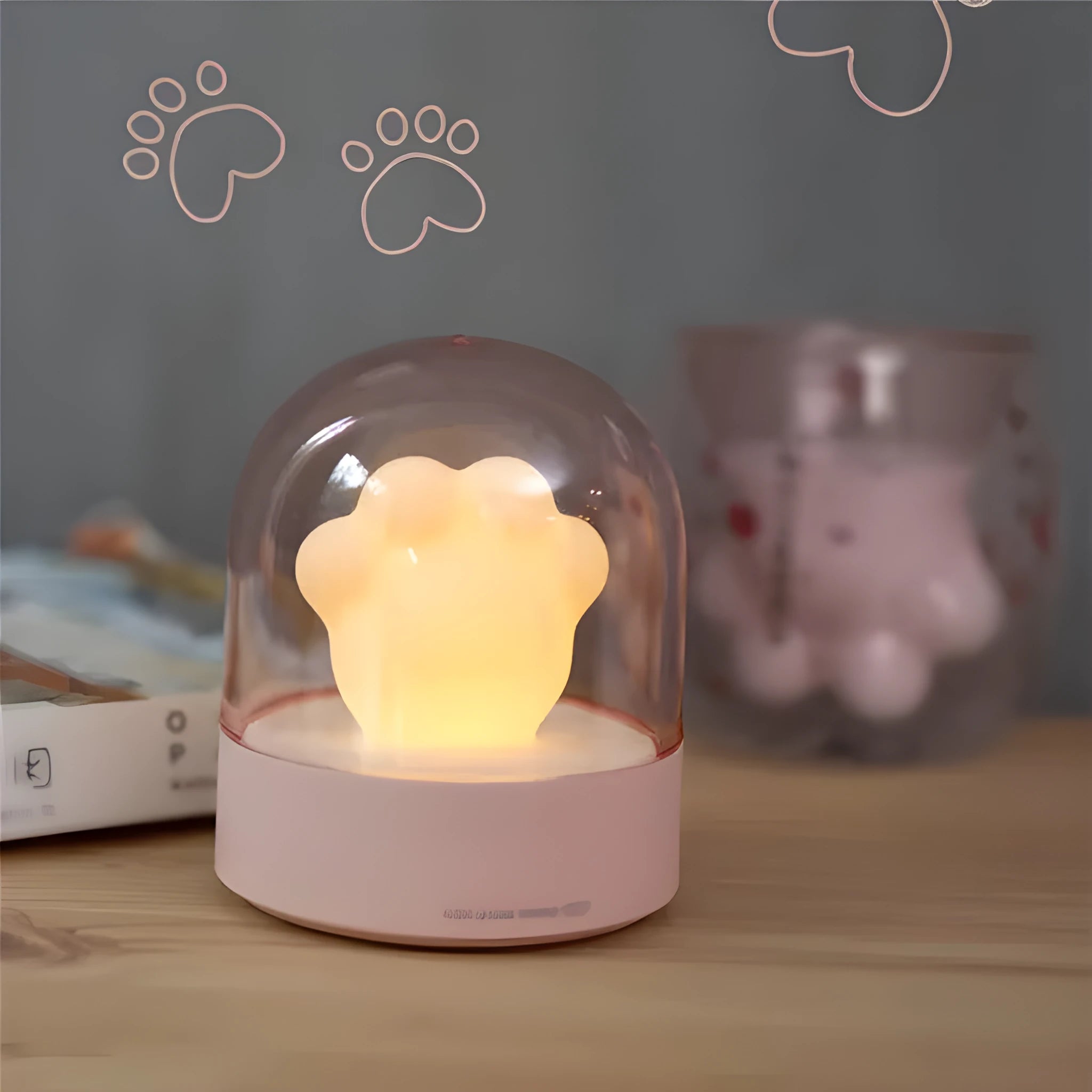 Grey and pink cat paw shaped USB rechargeable night light with music box on a desk