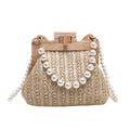 Women's woven straw shoulder bag with pearl chain strap in beige, showing its horizontal square shape.