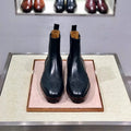 Men's black leather high-top business casual shoes on a neutral background.