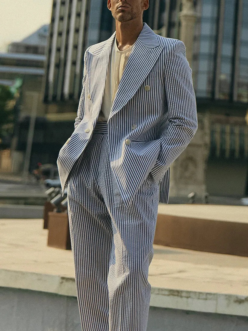 Blue and white striped polyester suit set with blazer and trousers on hanger