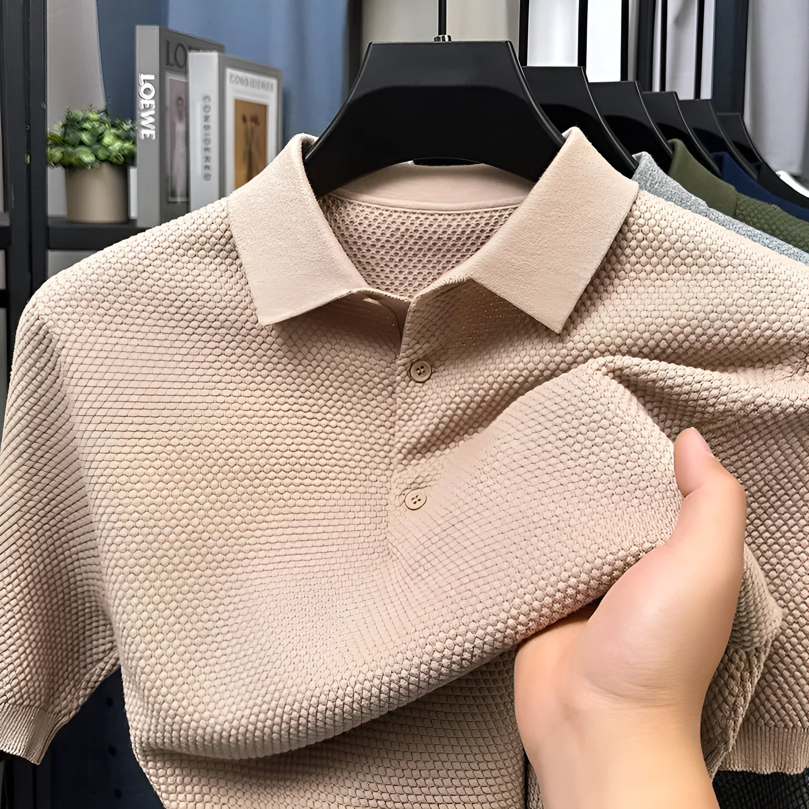 Man wearing a loose-fit grey short sleeve cotton pullover sweater for casual leisure wear.