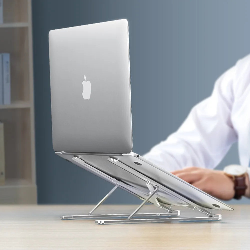 Aluminum foldable laptop stand in silver colour, shown adjusted to an elevated height with a laptop on top.