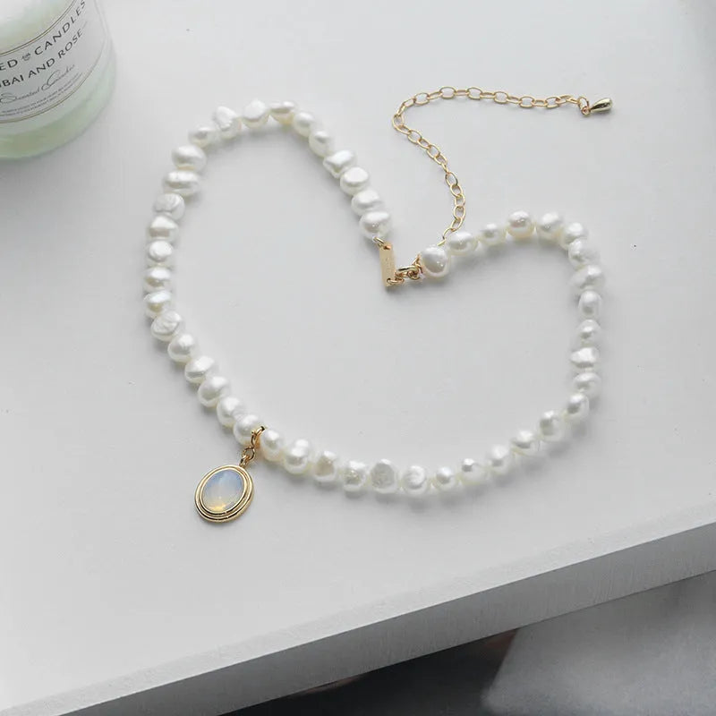 Silver necklace with geometric pendant and irregular pearls on adjustable chain