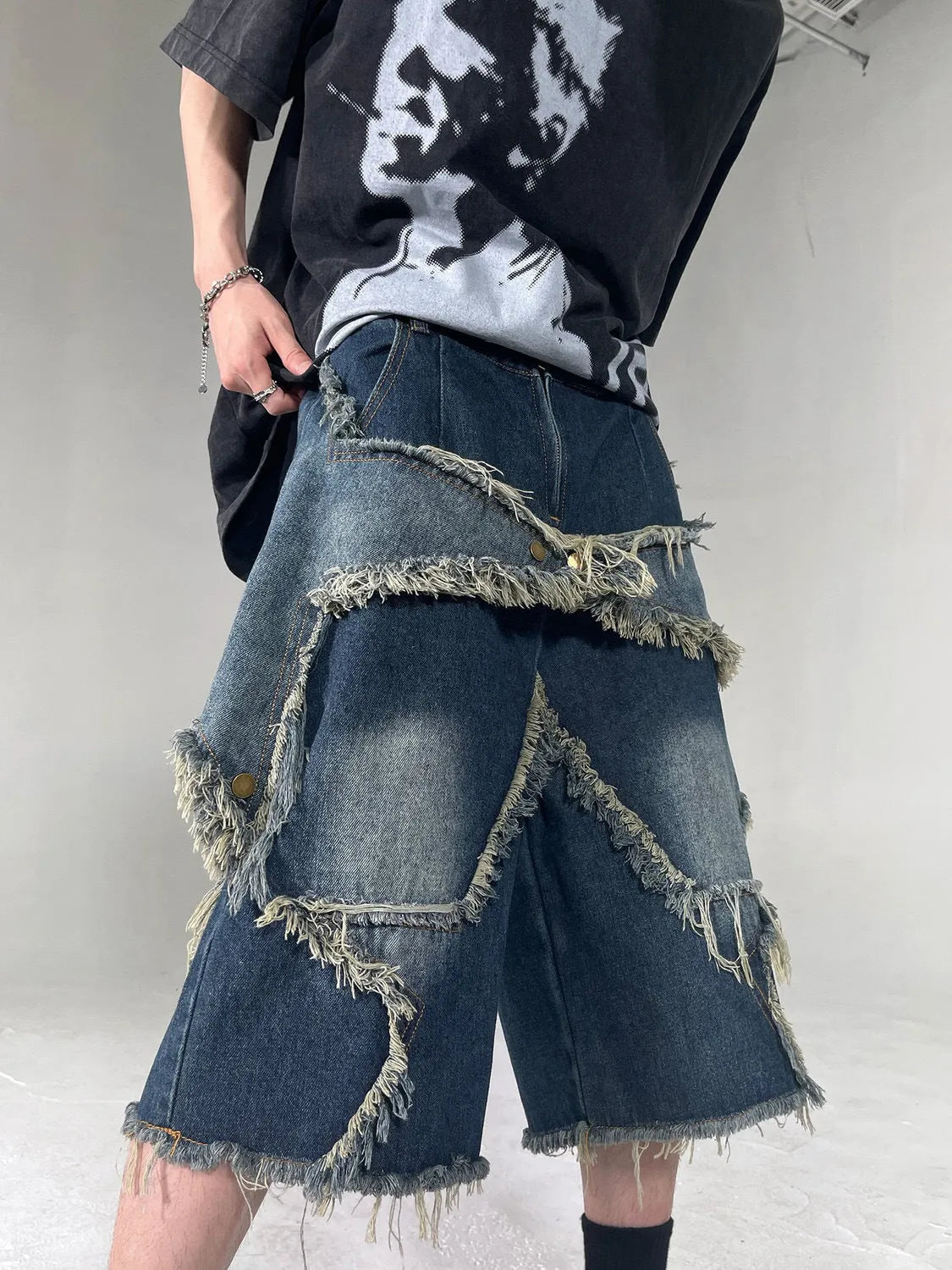 Blue men's denim shorts with frayed hem and five-pointed star patch in retro American style