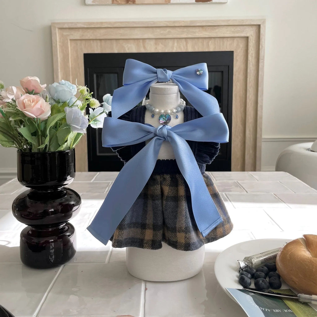 Blue princess-style bow dog hair band with adjustable tension on a model.