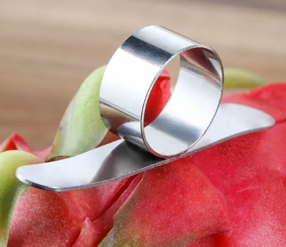 Silver stainless steel orange peeler ring on a citrus fruit