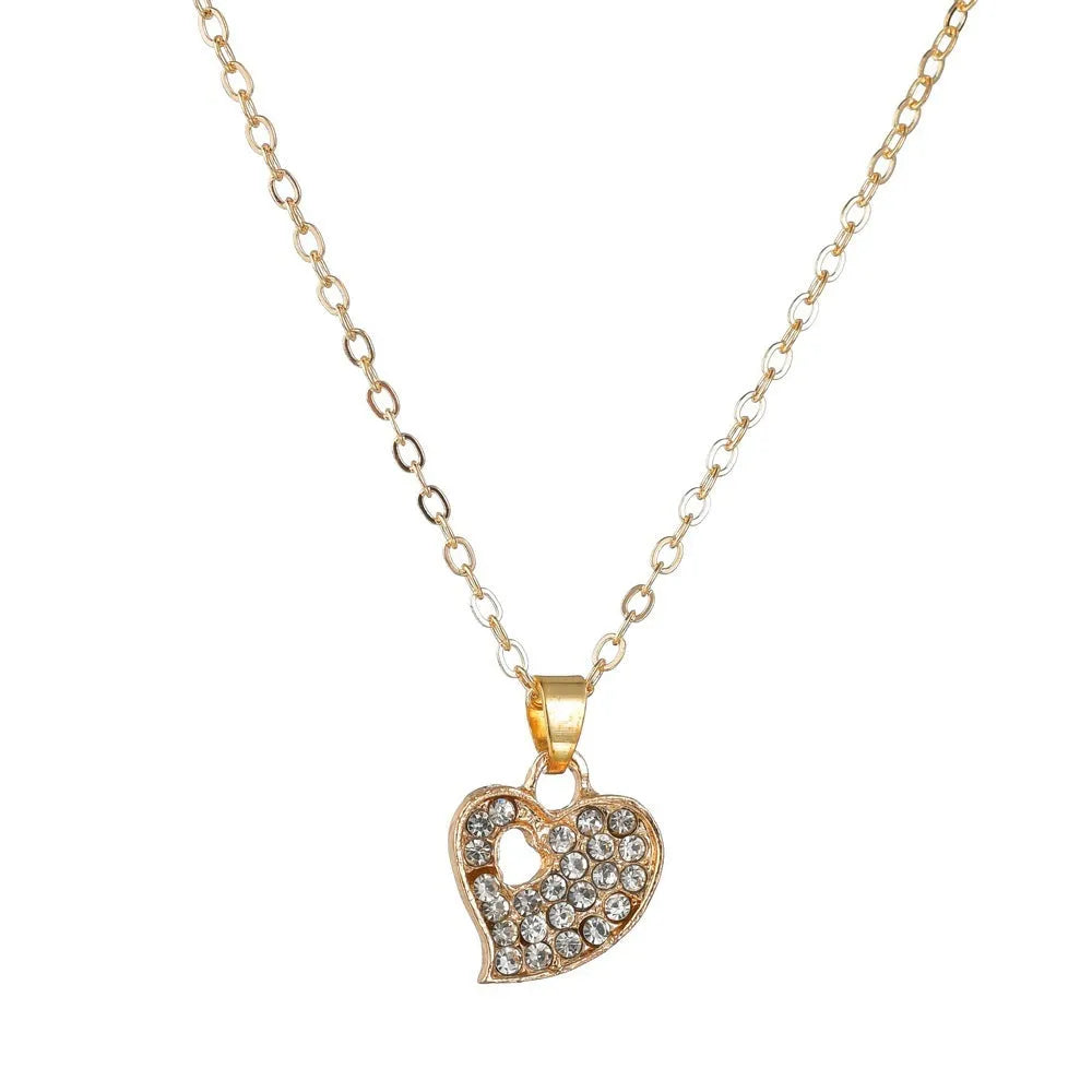 Gold-colour alloy jewellery set with earrings, pendant, and bracelet featuring love and bell patterns