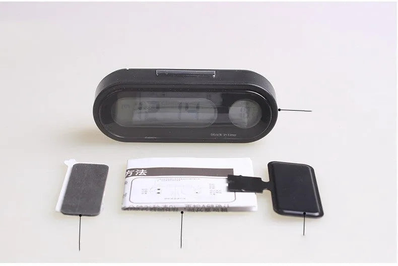 Black car clock thermometer with luminous LED display showing time and temperature on adjustable dashboard bracket