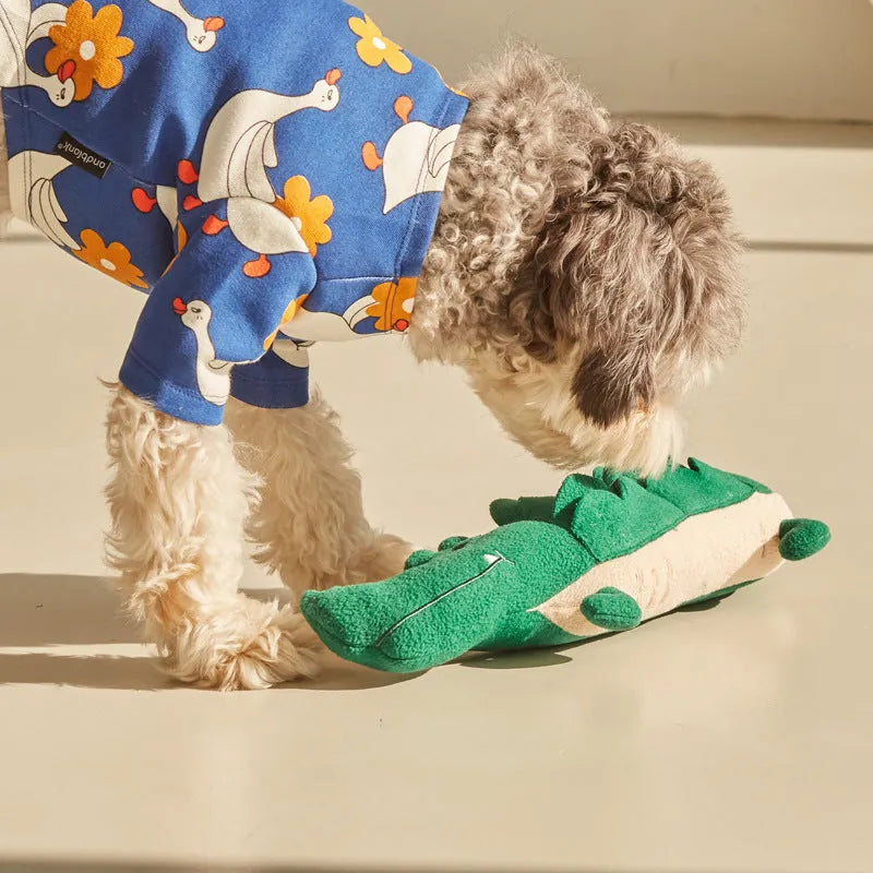 Green plush dog toy with squeaker measuring 35cm long on white background