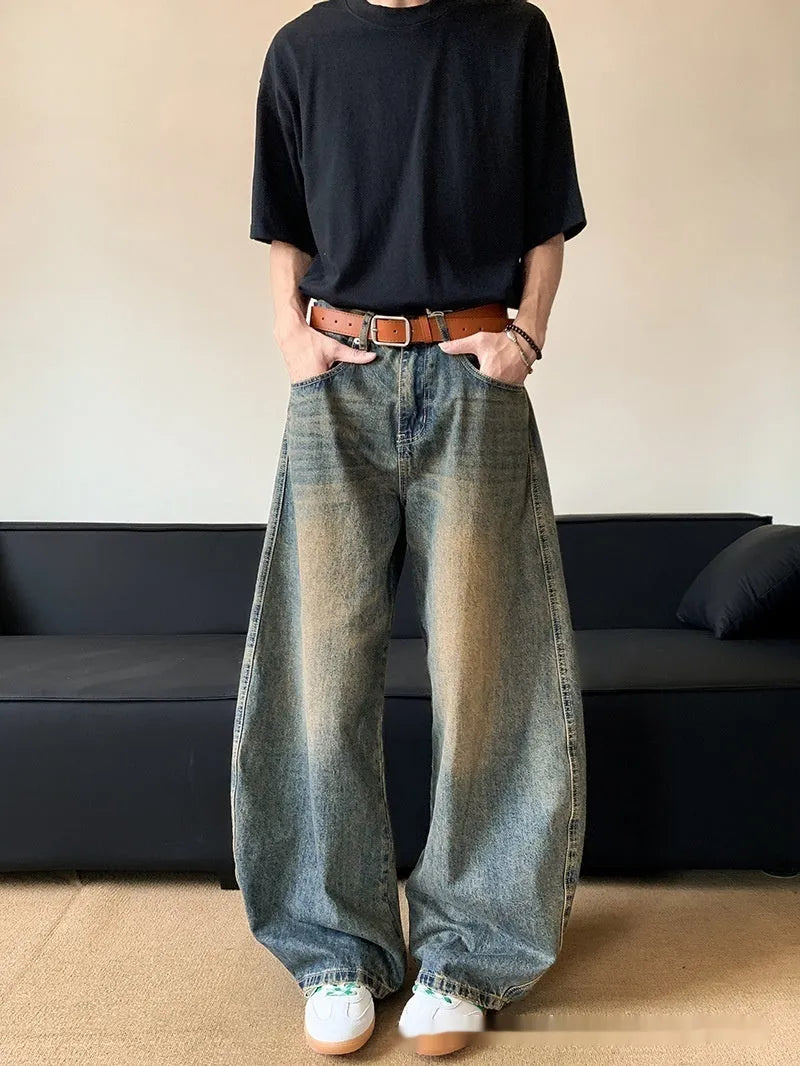Men's retro blue distressed denim jeans with a wide-leg slim fit and micro elasticity.