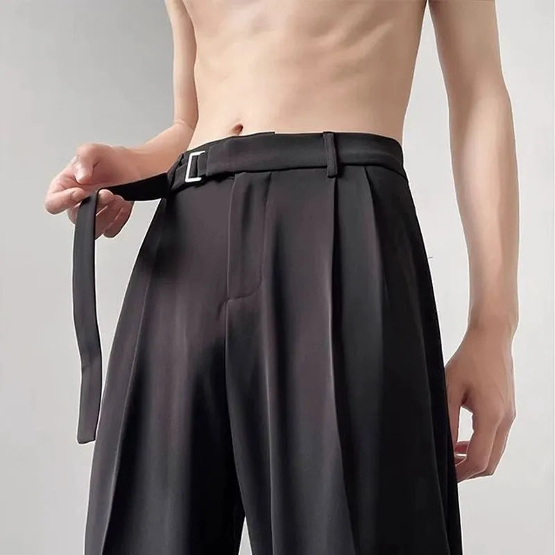 Black loose-fit wide-leg trousers with straight cut on a hanger.