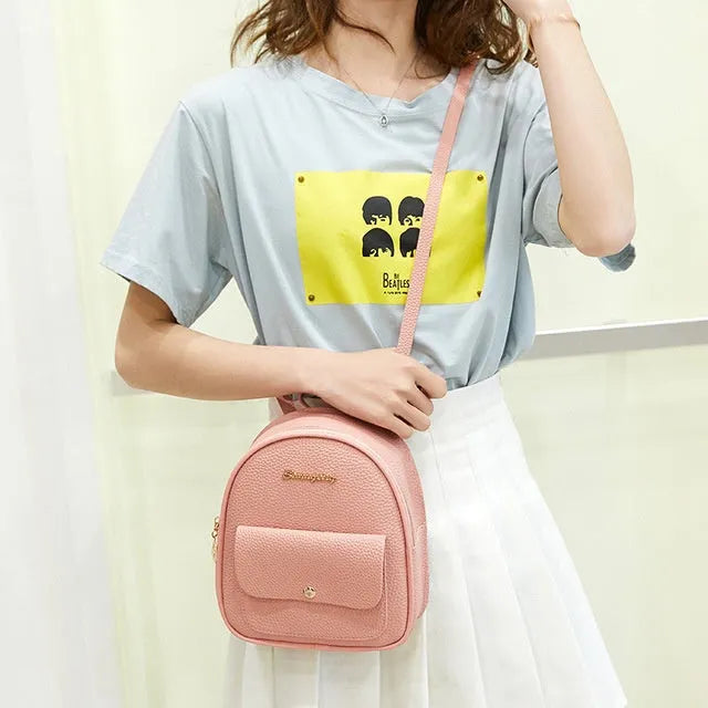 Small PU leather shoulder backpack in black colour showing zipper closure and compact dimensions