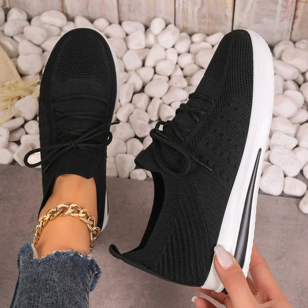 Women's fly-knit casual sneakers in solid black, blue, or red with a lace-up front and low-top design.