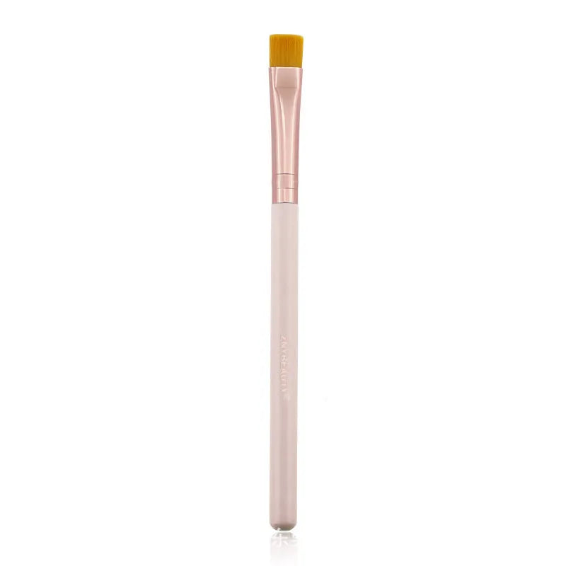 26 pink makeup brushes with wooden handles laid out next to a matching storage bag.