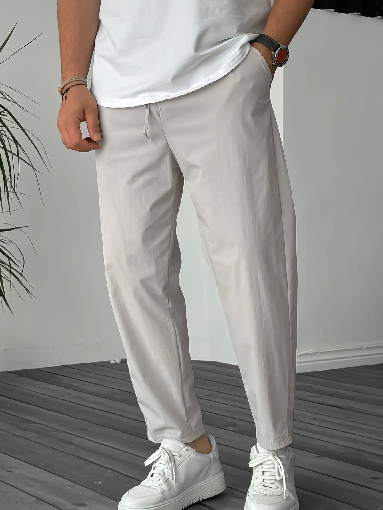 Men's khaki straight-leg casual trousers with drawstring waist and ribbon pockets.