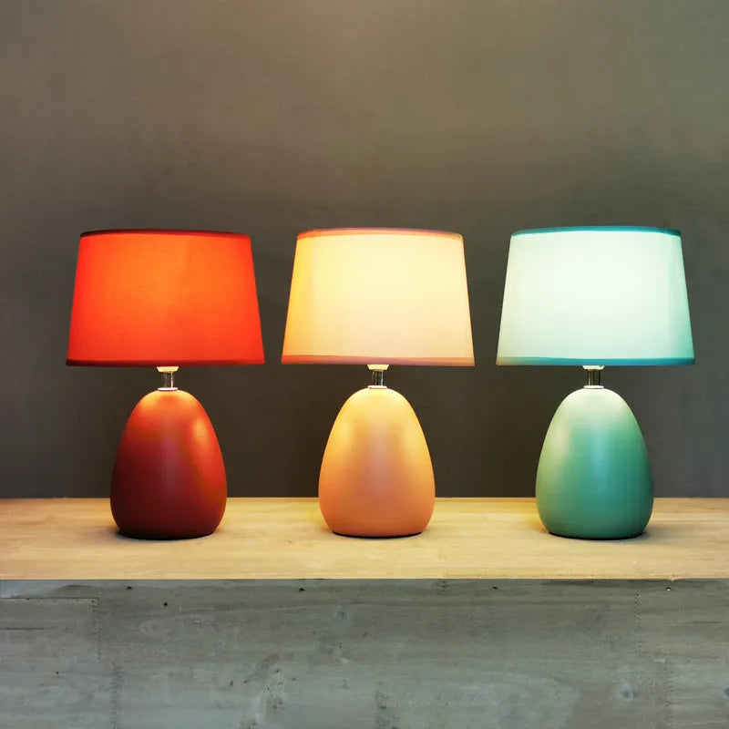 Small Nordic minimalist ceramic desk lamp in pink with LED light on desk