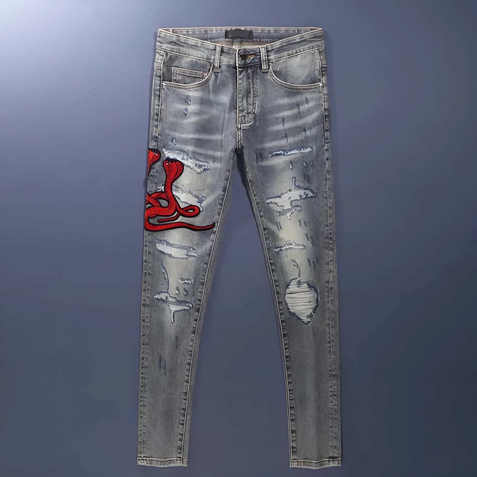 Men's slim fit jeans in old colour with a worn look, hole patches, and embroidered details on a mid-waist design.