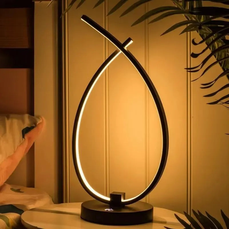 Black and white water drop shaped USB bedside lamp with touch and switch control.