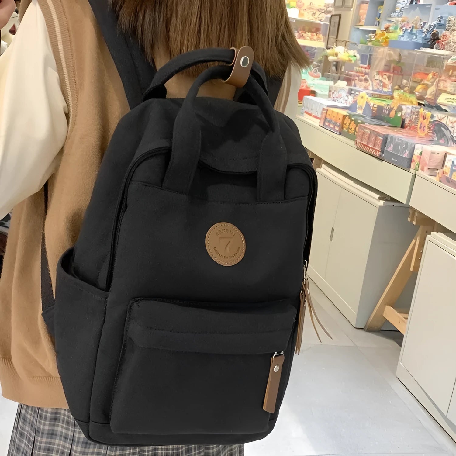 Black Oxford cloth leisure backpack with curved shoulder straps shown front view