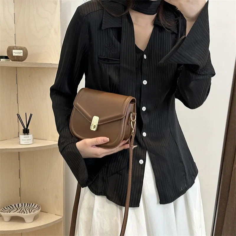 Soft horizontal square messenger bag in clamshell design, shown in black colour.