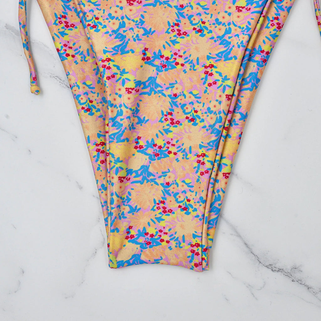 Women's lace-up bikini swimsuit in picture colour, showing backless design and high elasticity fabric.