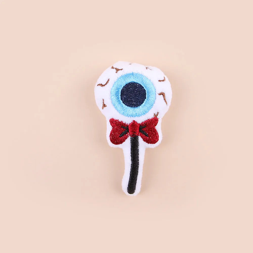 Small plush cat teaser wand with colourful eyes candy skull designs and feathers