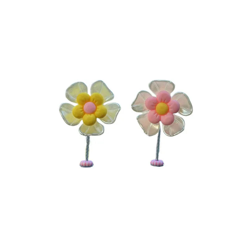 Small colourful plastic car swing decoration for dashboard or mirror.