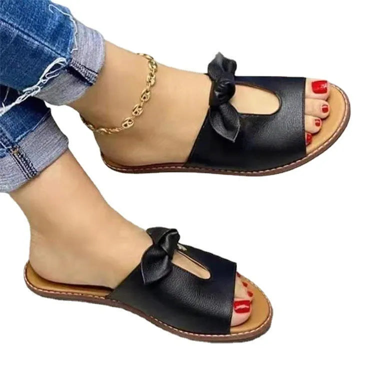 Ladies casual sandals in fish mouth slipper style with a bow, in black, pink, and gold colour options.