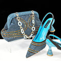 Women's pointed toe high heel shoe with rhinestones and matching small bag in blue.