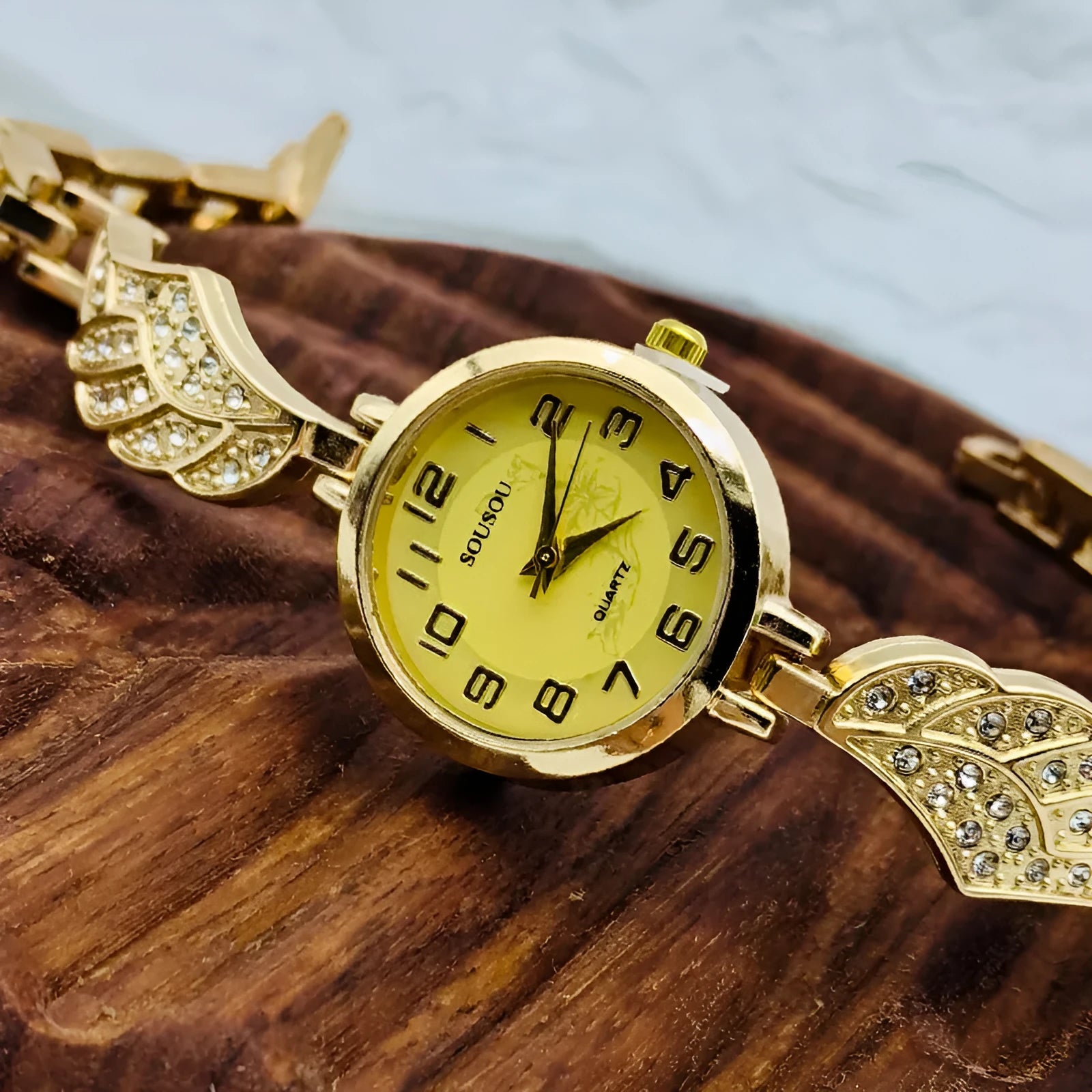 Women's stainless steel fashion watch with round dial showing gold surface option