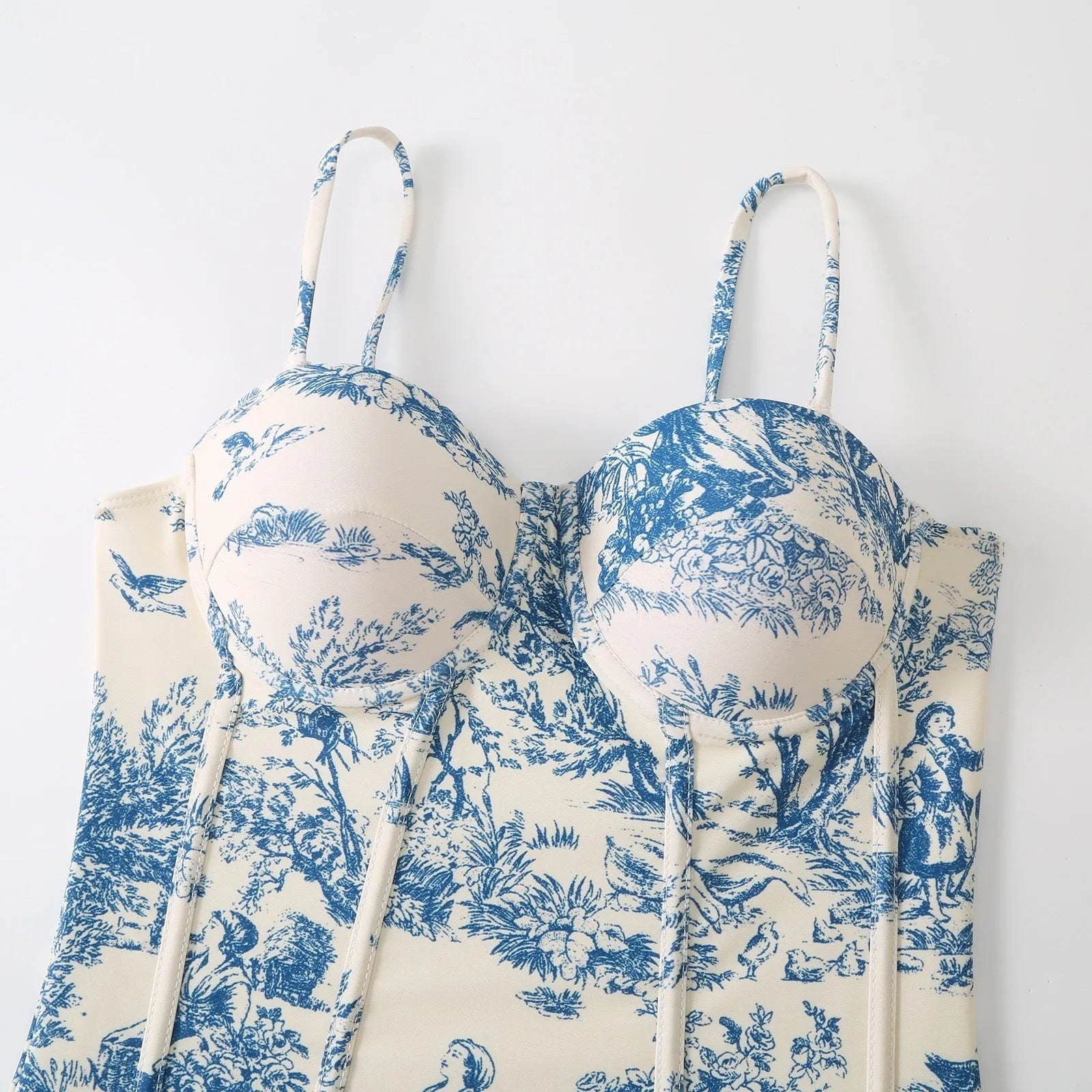Blue patterned one-piece swimsuit for women with optional gauze skirt, shown on a model.