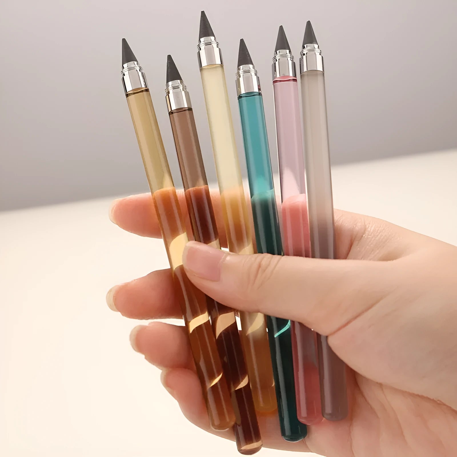 Transparent acrylic mechanical pencil with alloy tip showing colour lead options