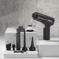 Black wireless car vacuum cleaner with multiple nozzle attachments including brush heads and suction tools