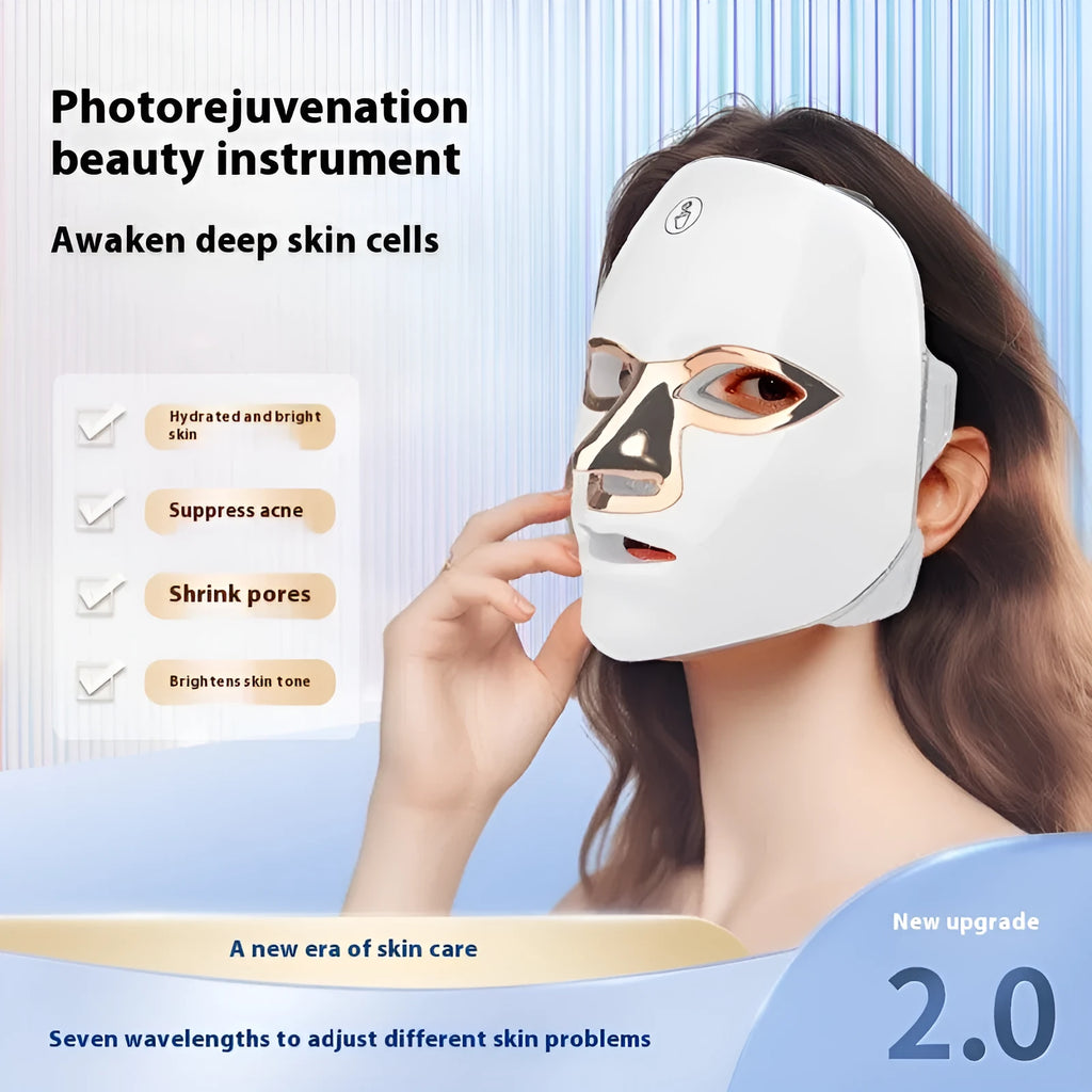 Rechargeable manual touch LED beauty mask in white with gold rim, showing charging cable and strap.