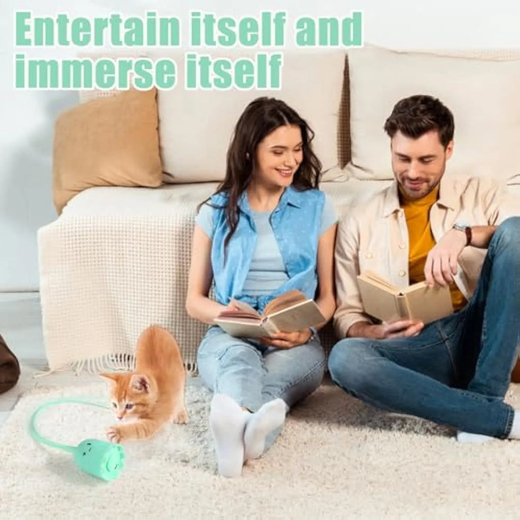Green automatic cat wand toy with swinging silicone tails on wooden floor