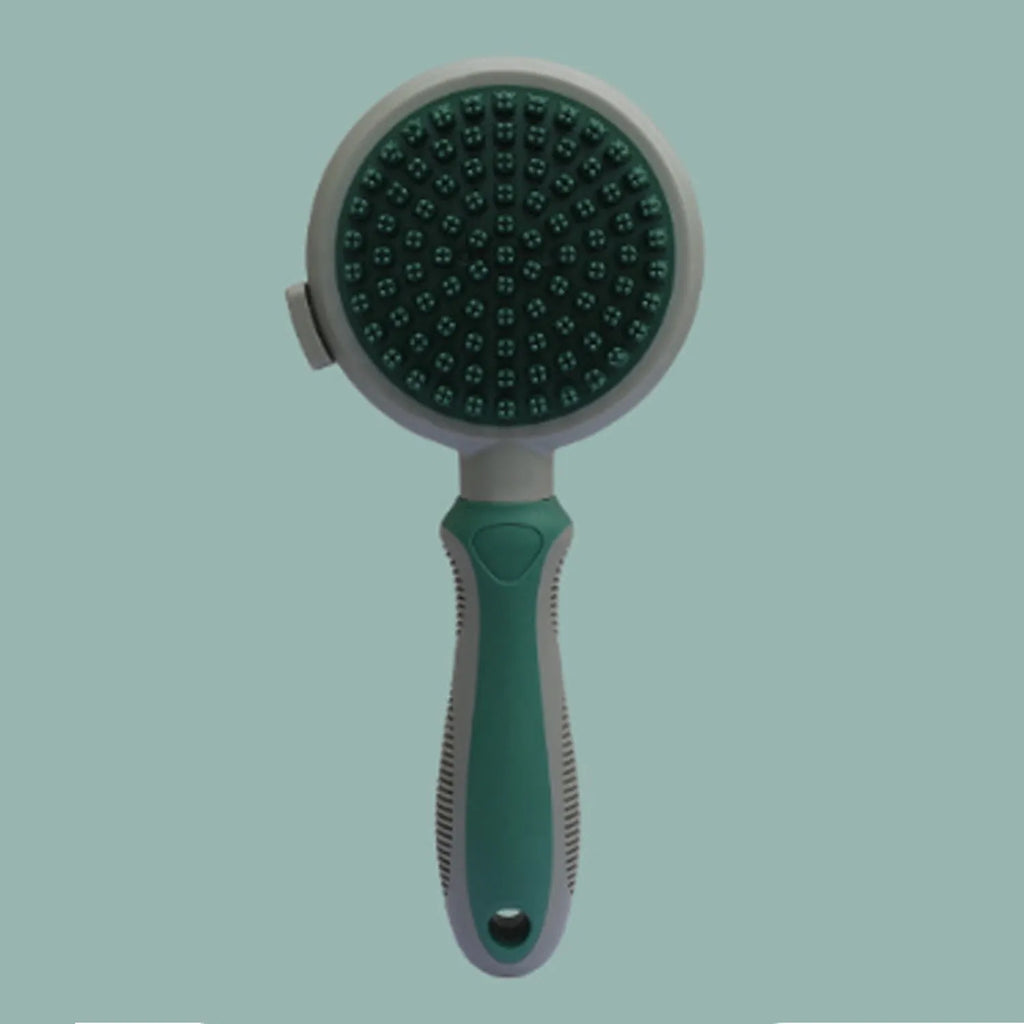 Green and pink double-sided cat grooming brush with slicker brush and flea comb, showing release button