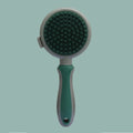 Green and pink double-sided cat grooming brush with slicker brush and flea comb, showing release button