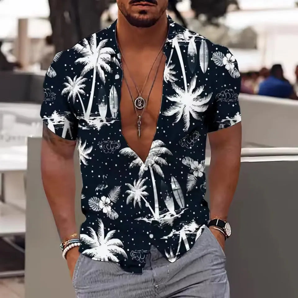 Man wearing a loose floral print short sleeve shirt in a cardigan style on a beach.
