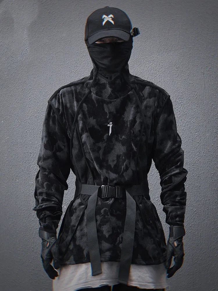 Man wearing a black and grey tie dye printed sweater with a finger turtleneck and drop shoulder sleeves.