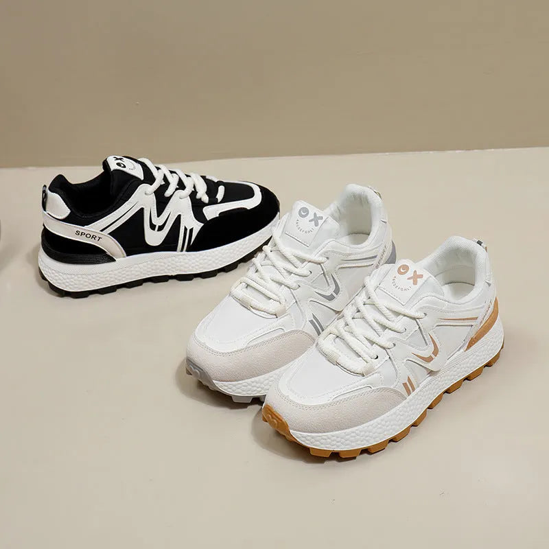 Women's black platform casual shoes with round toe and front lace-up design on a neutral background.