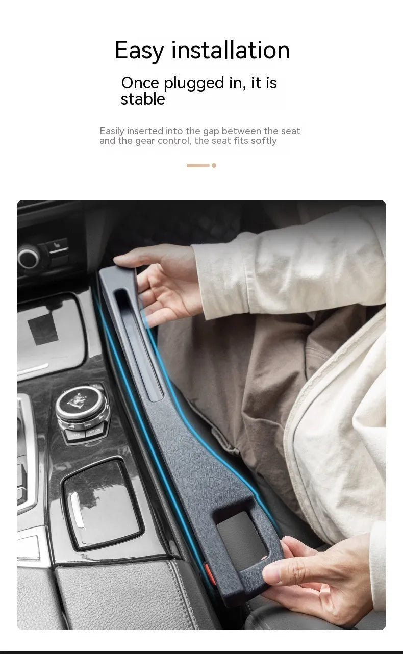 Black plastic car seat gap storage box with handle positioned between vehicle seats