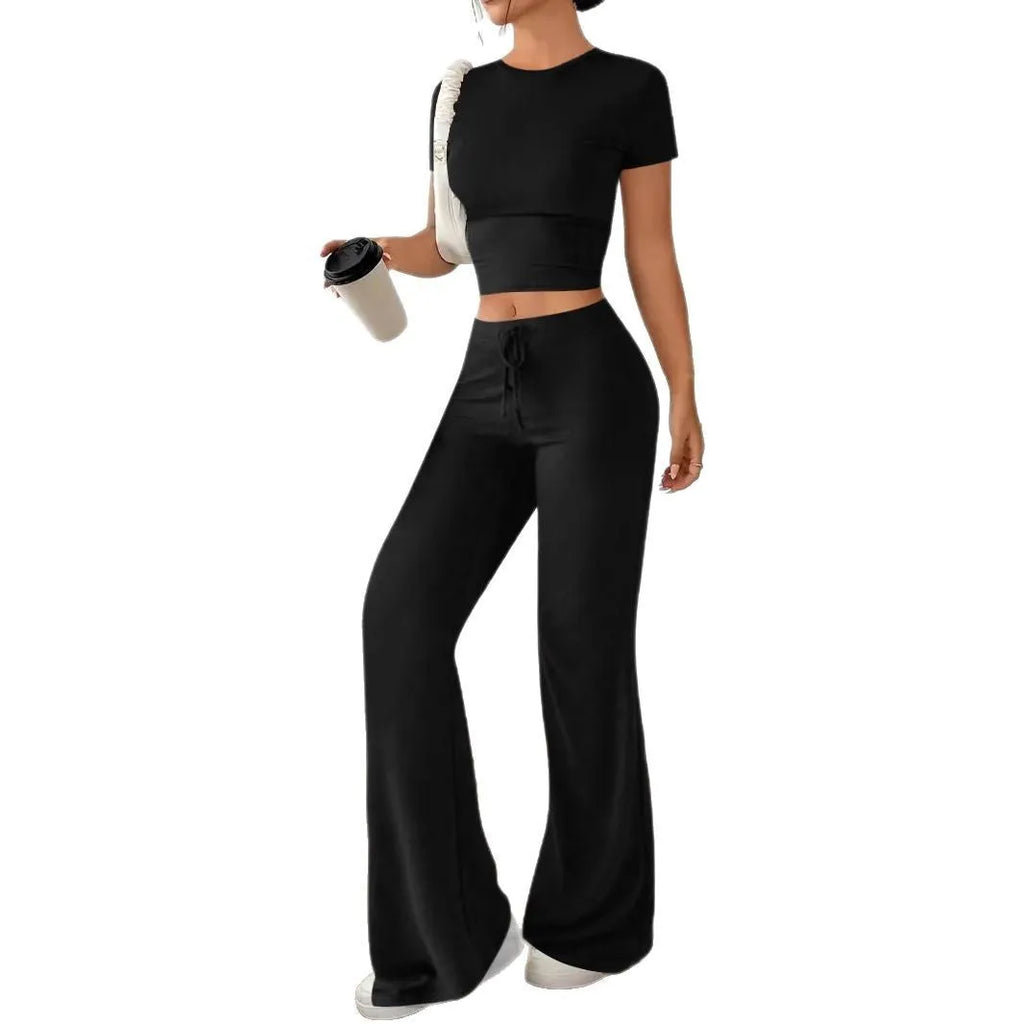 Black women's high waist trousers and short sleeve t-shirt co-ord set on a hanger.
