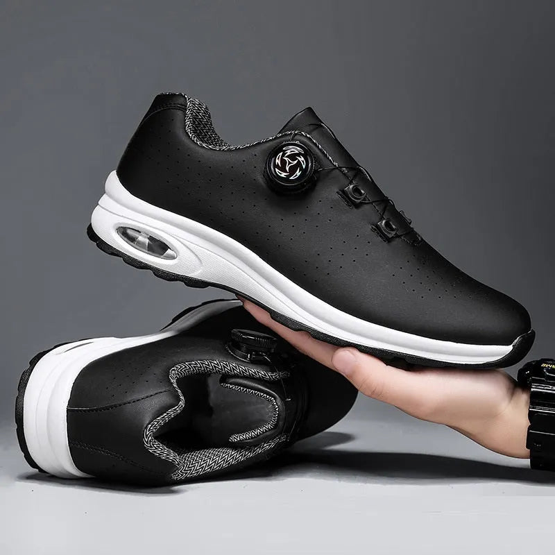 Black and white low-top casual tennis shoes with mesh upper, cross shoulder straps, and flat composite sole.