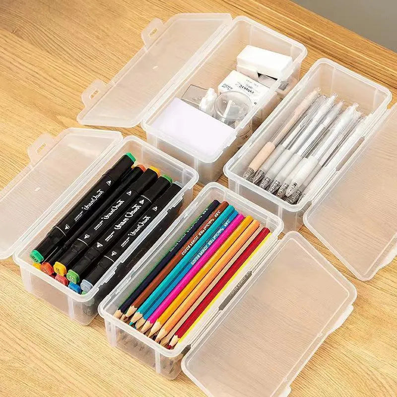 Transparent plastic stationery storage box containing pencils and drawing supplies