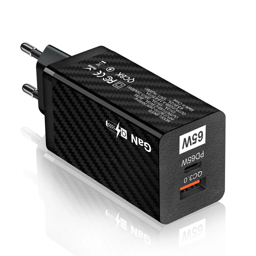 65W GaN fast charger showing compact size next to laptop with USB-C cable