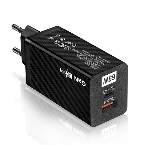 65W GaN fast charger showing compact size next to laptop with USB-C cable